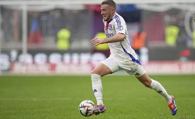 Lyon's Jordan Veretout runs with the ball during the French League One soccer match between Lyon and FC Nantes at the Groupama stadium in Decines, outside Lyon, France, Sunday, Oct. 6, 2024. (AP Photo/Laurent Cipriani)