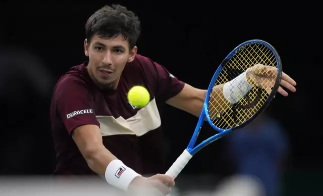 Alexei Popyrin, of Australia backhands to Russia's Daniil Medvedev during their second round match of the Paris Masters tennis tournament, Wednesday, Oct. 30, 2024 in Paris. (AP Photo/Michel Euler)