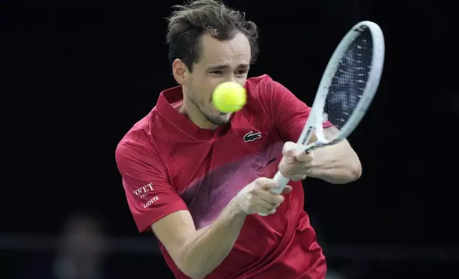 Russia's Daniil Medvedev returns the ball to Alexei Popyrin, of Australia, during their second round match of the Paris Masters tennis tournament, Wednesday, Oct. 30, 2024 in Paris. (AP Photo/Michel Euler)