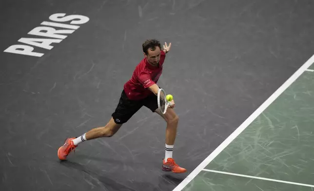 Russia's Daniil Medvedev returns the ball to Alexei Popyrin, of Australia, during their second round match of the Paris Masters tennis tournament, Wednesday, Oct. 30, 2024 in Paris. (AP Photo/Michel Euler)
