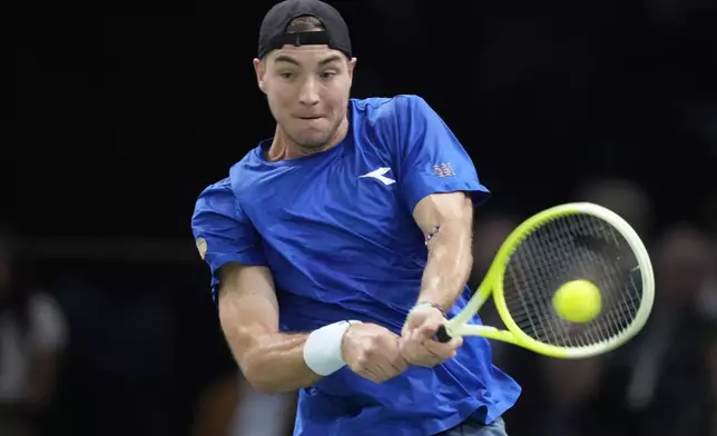 Jan-Lennard Struff, of Germany, returns the ball to France's Arthur Fils during their second round match of the Paris Masters tennis tournament, Wednesday, Oct. 30, 2024 in Paris. (AP Photo/Michel Euler)