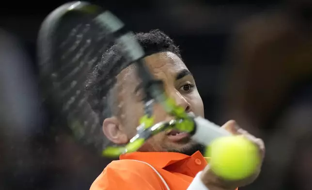 France's Arthur Fils returns the ball to Jan-Lennard Struff, of Germany, during their second round match of the Paris Masters tennis tournament, Wednesday, Oct. 30, 2024 in Paris. (AP Photo/Michel Euler)