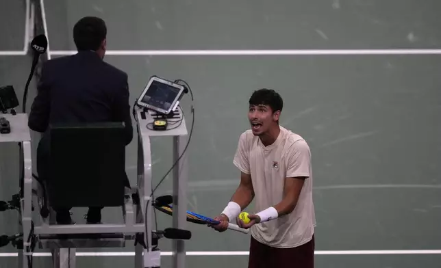 Alexei Popyrin, of Australia, argues with the chair umpire as he plays Russia's Daniil Medvedev during their second round match of the Paris Masters tennis tournament, Wednesday, Oct. 30, 2024 in Paris. (AP Photo/Michel Euler)