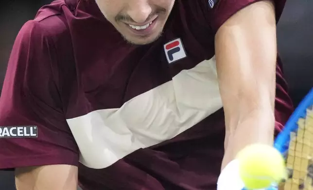 Alexei Popyrin, of Australia, returns the ball to Russia's Daniil Medvedev during their second round match of the Paris Masters tennis tournament, Wednesday, Oct. 30, 2024 in Paris. (AP Photo/Michel Euler)