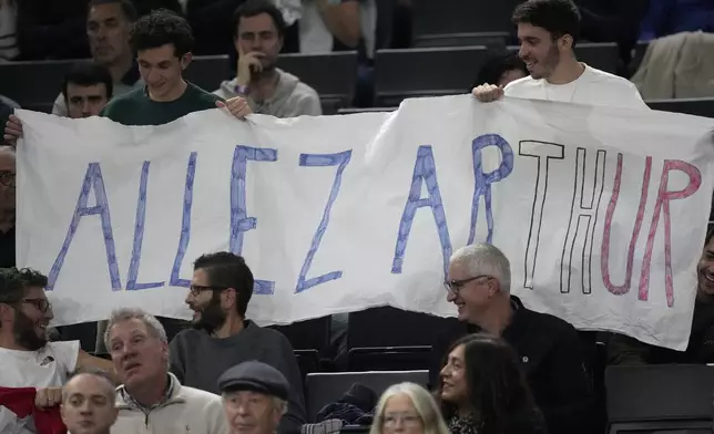 Spectators display a banner reading "Go on Arthur" as France's Arthur Fils plays Jan-Lennard Struff of Germany during their second round match of the Paris Masters tennis tournament, Wednesday, Oct. 30, 2024 in Paris. (AP Photo/Michel Euler)