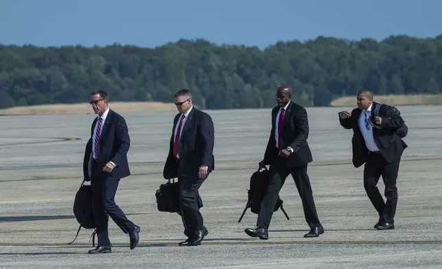 FILE - Members of President Joe Biden's Secret Service detail walk to Air Force One at Andrews Air Force Base, Md., Monday, July 15, 2024. (AP Photo/Cliff Owen, File)