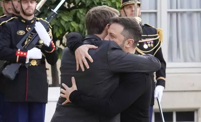 French President Emmanuel Macron, left, greets his Ukrainian counterpart Volodymyr Zelenskyy before a meeting at the Elysee Palace, in Paris, Thursday, Oct. 10, 2024. (AP Photo/Michel Euler)