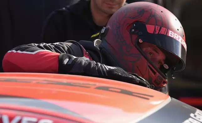 Keanu Reeves climbs out of his car following a GR Cup Series auto race at Indianapolis Motor Speedway, Saturday, Oct. 5, 2024, in Indianapolis. (AP Photo/Darron Cummings)