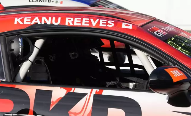 Keanu Reeves sits in his car before a GR Cup Series auto race at Indianapolis Motor Speedway, Saturday, Oct. 5, 2024, in Indianapolis. (AP Photo/Darron Cummings)