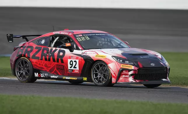 Keanu Reeves drives during the GR Cup Series auto race at Indianapolis Motor Speedway, Saturday, Oct. 5, 2024, in Indianapolis. (AP Photo/Darron Cummings)