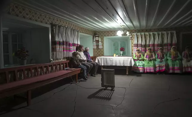 Yuri Strukov, second left, and his son Ilya, left, pray at the former Orphanage house where Doukhobors has worshiped for years, on Easter in the remote mountain village of Gorelovka, Georgia, Saturday, May 4, 2024. (AP Photo/Kostya Manenkov)