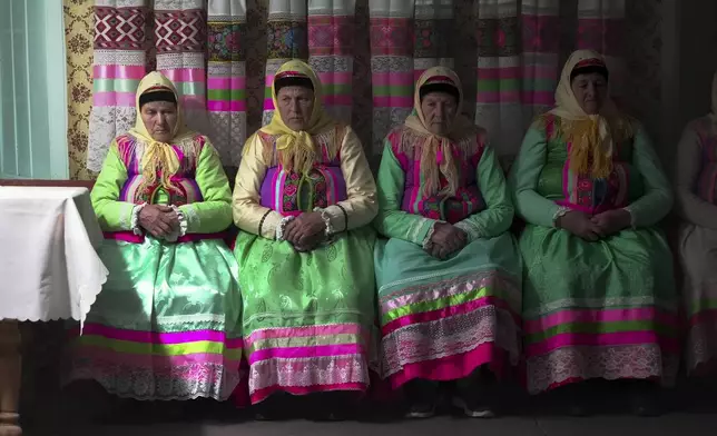 Women in traditional Doukhobor dresses pray at the former Orphanage house where Doukhobors has worshiped for years, on Easter in the remote mountain village of Gorelovka, Georgia, Saturday, May 4, 2024. (AP Photo/Kostya Manenkov)