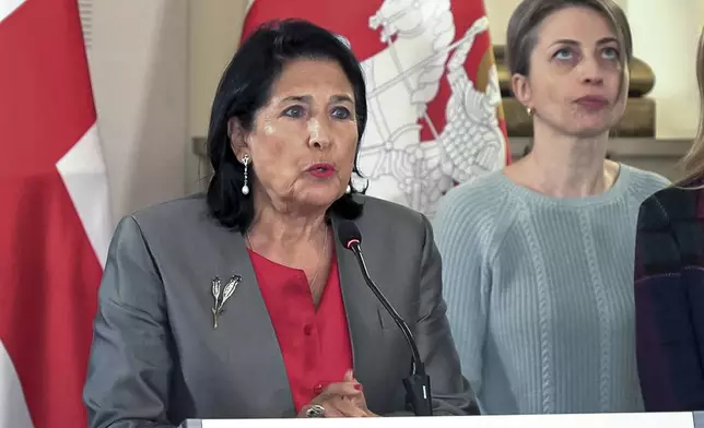 In this photo taken from video, Georgian President Salome Zourabichvili, left, speaks to the media as speaks to the media as and Nana Malashkhia, who leads the Coalition for Change parliament list, right, stands near, after the parliamentary election in Tbilisi, Georgia, on Sunday, Oct. 27, 2024. (AP Photo/Kostya Manenkov)