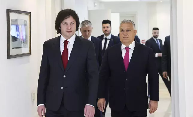 In this photo released by Georgian Prime Minister Press Office on Tuesday, Oct. 29, 2024, Georgian Prime Minister Irakli Kobakhidze, left, and Prime Minister of Hungary Viktor Orban walk during their meeting in Tbilisi, Georgia. (Georgian Prime Minister Press Office via AP)