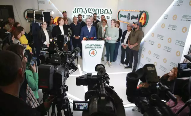 Nika Gvaramia, leader of Coalition for Changes, center, speaks to the media at coalition's headquarters after the parliamentary election in Tbilisi, Georgia, Sunday, Oct. 27, 2024. (AP Photo/Zurab Tsertsvadze)