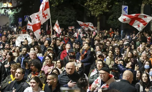 Demonstrators wave Georgian national flags during an opposition protest against the results of the parliamentary election in Tbilisi, Georgia, Monday, Oct. 28, 2024. (AP Photo/Zurab Tsertsvadze)