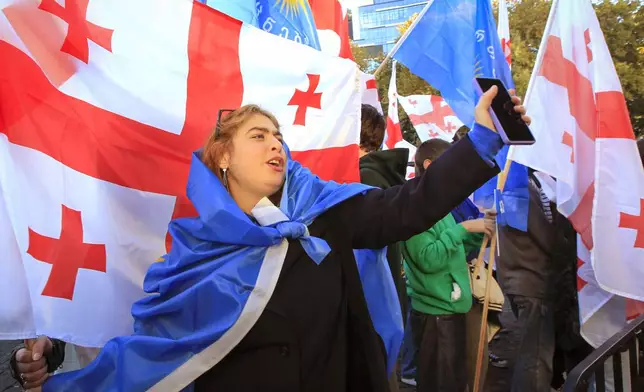 Supporters of the ruling Georgian Dream party attend a rally in the center of Tbilisi, Georgia, Wednesday, Oct. 23, 2024. (AP Photo/Shakh Aivazov)