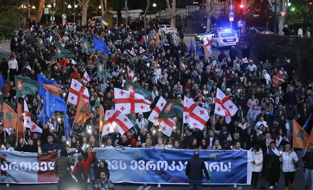 Demonstrators march during an opposition rally ahead upcoming next week parliamentary election in Tbilisi, Georgia, Sunday, Oct. 20, 2024. (AP Photo/Zurab Tsertsvadze)