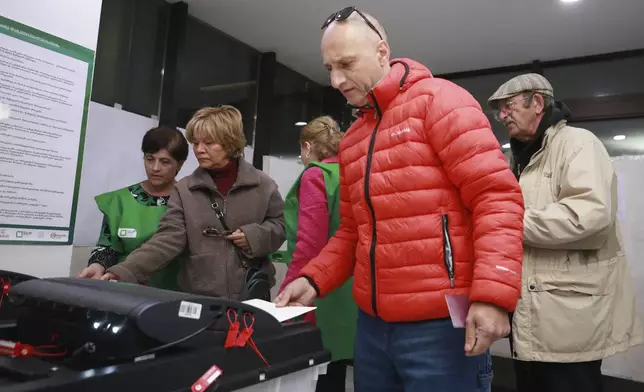 People cast their ballots at a polling station during the parliamentary election in Tbilisi, Georgia, Saturday, Oct. 26, 2024. (AP Photo/Zurab Tsertsvadze)