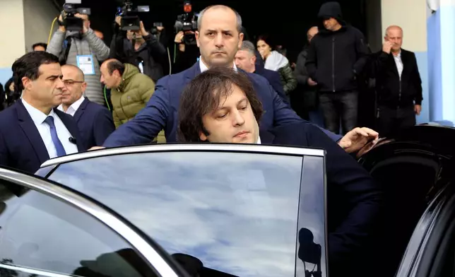 Georgian Prime Minister Irakli Kobakhidze gets into a car after voting at a polling station during the parliamentary election in Tbilisi, Georgia, Saturday, Oct. 26, 2024. (AP Photo/Shakh Aivazov)