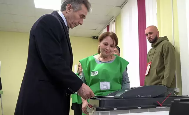 In this photo taken from video, Bidzina Ivanishvili, leader of the created by him the Georgian Dream party votes at a polling station during the parliamentary election in Tbilisi, Georgia, Saturday, Oct. 26, 2024. (AP Photo/Kostya Manenkov)
