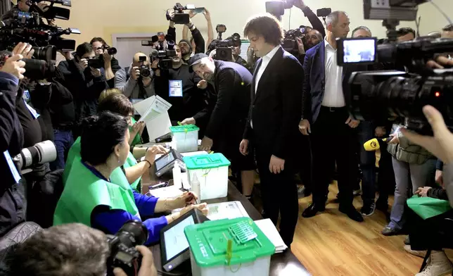 Georgian Prime Minister Irakli Kobakhidze gets his ballot at a polling station during the parliamentary election in Tbilisi, Georgia, Saturday, Oct. 26, 2024. (AP Photo/Shakh Aivazov)