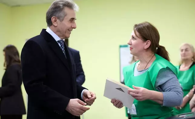 In this photo released by Georgian Dream party press service, Bidzina Ivanishvili, leader of the created by him the Georgian Dream party, arrives to vote at a polling station during the parliamentary election in Tbilisi, Georgia, Saturday, Oct. 26, 2024. (Georgian Dream party press service via AP)