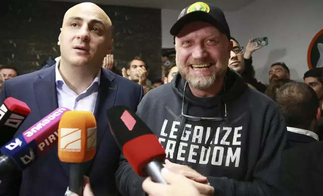 From left, Nika Melia, leader of Coalition for Changes, and Zurab Japaridze, chairman of the Girchi More Freedom party, talk to journalists at coalition's headquarters after polls closing at the parliamentary election in Tbilisi, Georgia, Saturday, Oct. 26, 2024. (AP Photo/Zurab Tsertsvadze)