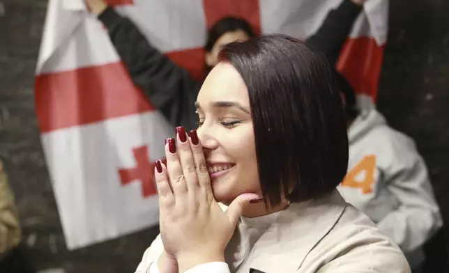 A supporter of the Coalition for Change reacts at coalition's headquarters after polls closing at the parliamentary election in Tbilisi, Georgia, Saturday, Oct. 26, 2024. (AP Photo/Zurab Tsertsvadze)