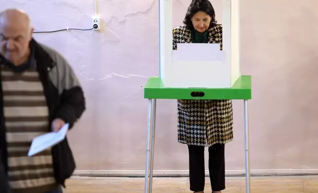 Georgian President Salome Zourabichvili fills her ballot at a polling station during the parliamentary election in Tbilisi, Georgia, Saturday, Oct. 26, 2024. (AP Photo/Shakh Aivazov)
