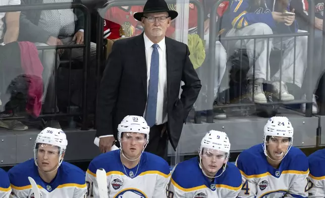 Buffalo Sabres NHL hockey team head coach Lindy Ruff watches from the bench during an ice hockey match against Red Bull Munich in Munich, Germany, Friday, Sept. 27, 2024.(Sven Hoppe/dpa via AP)