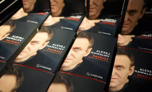 Copies of the late Russian opposition leader Alexei Navalny's memoir entitled 'Patriot' are put display on the first day of sale in a bookshop in Berlin, Germany, Tuesday, Oct. 22, 2024. (AP Photo/Markus Schreiber)