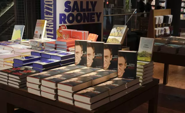 Copies of the late Russian opposition leader Alexei Navalny's memoir entitled 'Patriot' are put display on the first day of sale in a bookshop in Berlin, Germany, Tuesday, Oct. 22, 2024. (AP Photo/Markus Schreiber)