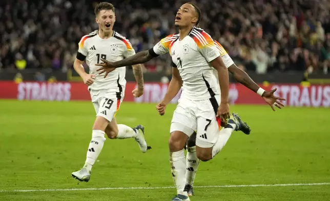 Germany's scorer Jamie Leweling celebrates after scoring the opening goal during the UEFA Nations League group 3 soccer match between Germany and The Netherlands in Munich, Germany, Monday, Oct. 14, 2024. (AP Photo/Matthias Schrader)