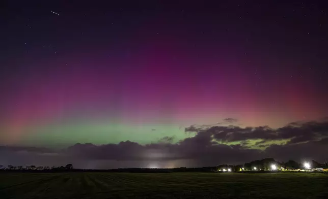 Northern lights illuminate the sky near Harrislee, Germany, Thursday, Oct. 10, 2024. (Benjamin Nolte/dpa via AP)