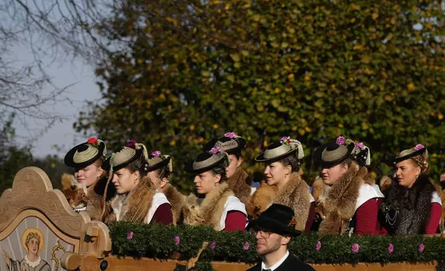 Women in traditional costumes of the region take part at the traditional Leonhardi pilgrimage in Warngau near Munich, Germany, Sunday, Oct. 27, 2024. The annual pilgrimage honors St. Leonhard, patron saint of the highland farmers for horses and livestock. (AP Photo/Matthias Schrader)