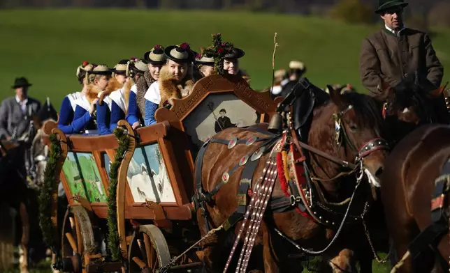 Women in traditional costumes of the region take part at the traditional Leonhardi pilgrimage in Warngau near Munich, Germany, Sunday, Oct. 27, 2024. The annual pilgrimage honors St. Leonhard, patron saint of the highland farmers for horses and livestock. (AP Photo/Matthias Schrader)