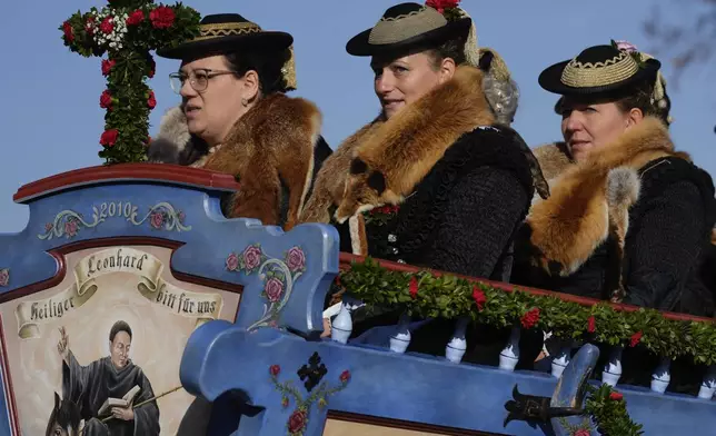 Women in traditional costumes of the region take part at the traditional Leonhardi pilgrimage in Warngau near Munich, Germany, Sunday, Oct. 27, 2024. The annual pilgrimage honors St. Leonhard, patron saint of the highland farmers for horses and livestock. (AP Photo/Matthias Schrader)