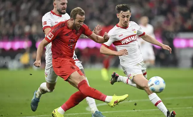 Munich's Harry Kane, left, plays against Stuttgart's Jeff Chabot during a German Bundesliga soccer match between FC Bayern Munich and VfB Stuttgart, in Munich, Germany, Saturday, Oct. 19, 2024. (Sven Hoppe/dpa via AP)