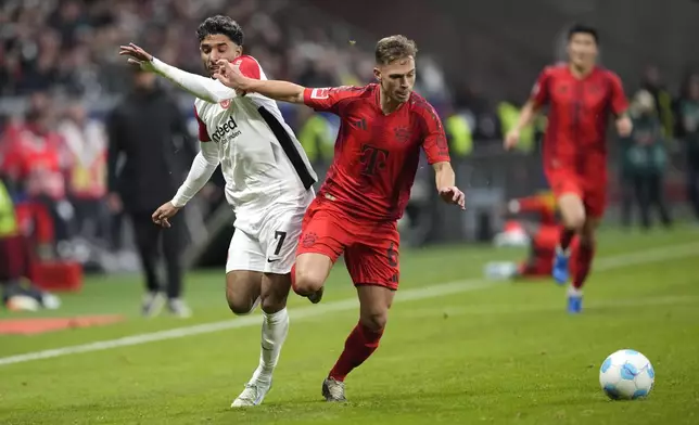 Frankfurt's Omar Marmoush, left, and Bayern's Joshua Kimmich challenge for the ball during the German Bundesliga soccer match between Eintracht Frankfurt and Bayern Munich in Frankfurt, Germany, Sunday, Oct. 6, 2024. (AP Photo/Michael Probst)