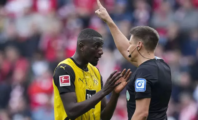 Dortmund's Sebastien Haller talks to a referee during the Bundesliga soccer match between Union Berlin and Borussia Dortmund in Berlin, Germany, on Saturday, Oct. 5, 2024.(AP Photo/Ebrahim Noroozi)