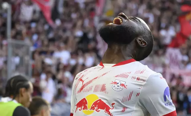 Leipzig's Lutsharel Geertruida celebrates after scoring during the German Bundesliga soccer match between RB Leipzig and SC Freiburg at the Red Bull Arena in Leipzig, Germany, Saturday, Oct. 26, 2024. (Hendrik Schmidt/dpa via AP)