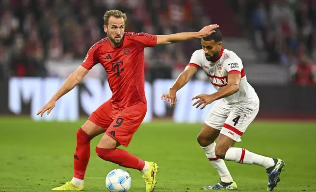 Munich's Harry Kane, left, and Stuttgart's Josha Vagnoman battle for the ball during a German Bundesliga soccer match between FC Bayern Munich and VfB Stuttgart, in Munich, Germany, Saturday, Oct. 19, 2024. (Tom Weller/dpa via AP)