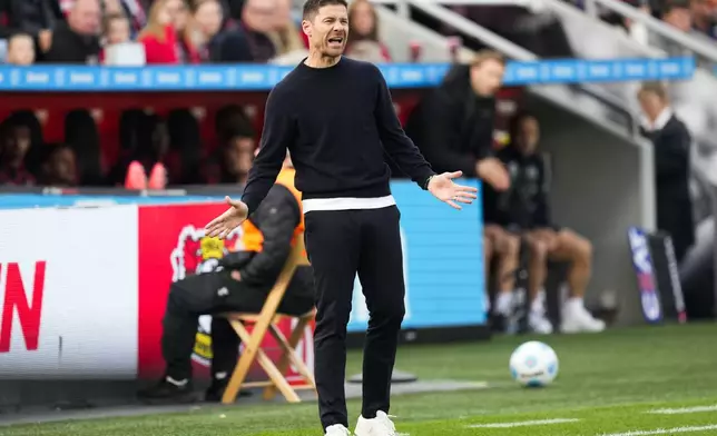 Leverkusen's head coach Xabi Alonso reacts during the German Bundesliga soccer match between Bayer Leverkusen and Holstein Kiel at the BayArena in Leverkusen, Germany, Saturday, Oct. 5, 2024. (AP Photo/Martin Meissner)