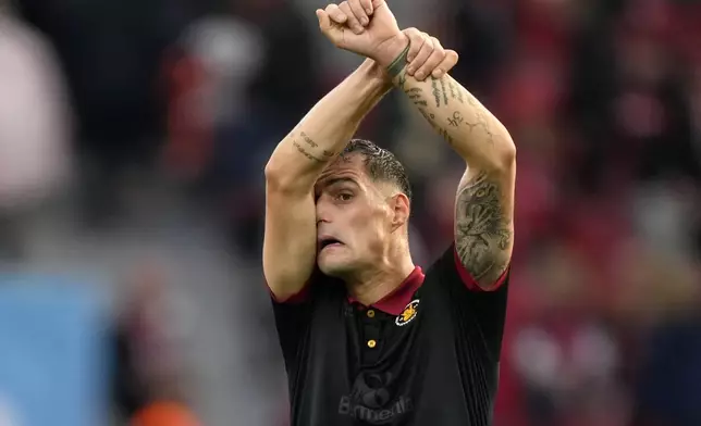 Leverkusen's Granit Xhaka reacts after his team failed to win the German Bundesliga soccer match between Bayer Leverkusen and Holstein Kiel at the BayArena in Leverkusen, Germany, Saturday, Oct. 5, 2024. (AP Photo/Martin Meissner)