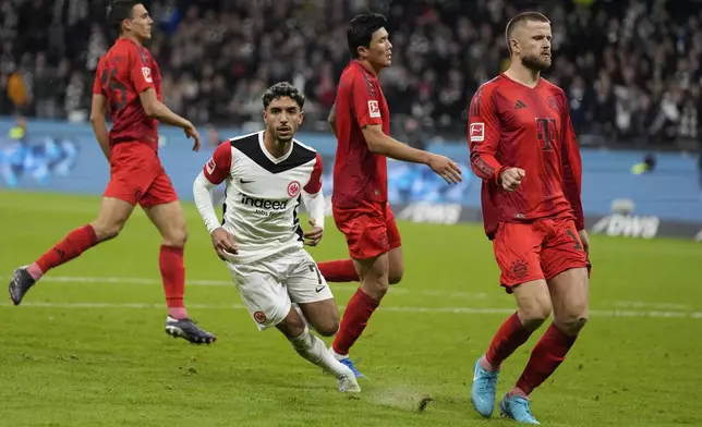 Frankfurt's Omar Marmoush, centre, celebrates after scoring his side's third goal during the German Bundesliga soccer match between Eintracht Frankfurt and Bayern Munich in Frankfurt, Germany, Sunday, Oct. 6, 2024. (AP Photo/Michael Probst)