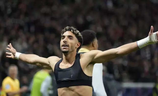 Frankfurt's Omar Marmoush celebrates after scoring his side's third goal during the German Bundesliga soccer match between Eintracht Frankfurt and Bayern Munich in Frankfurt, Germany, Sunday, Oct. 6, 2024. (AP Photo/Michael Probst)