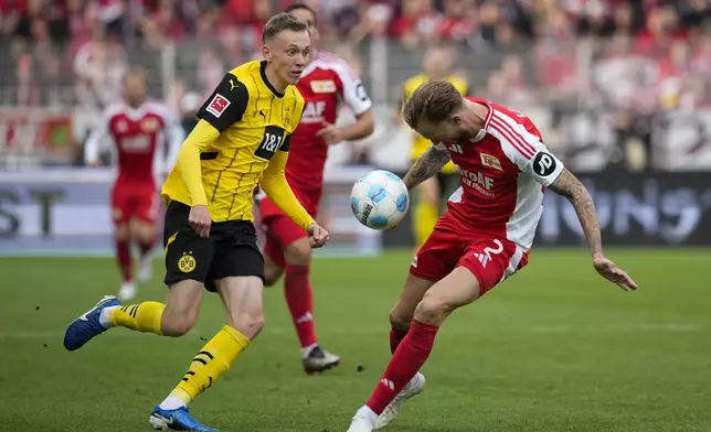 Union's Kevin Vogt stops the ball in front of Dortmund's Julien Duranville during the Bundesliga soccer match between Union Berlin and Borussia Dortmund in Berlin, Germany, on Saturday, Oct. 5, 2024.(AP Photo/Ebrahim Noroozi)