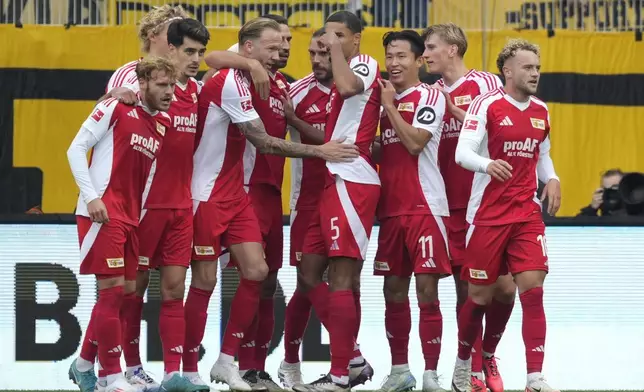 Berlin players celebrate after a goal during the Bundesliga soccer match between Union Berlin and Borussia Dortmund in Berlin, Germany, on Saturday, Oct. 5, 2024.(AP Photo/Ebrahim Noroozi)