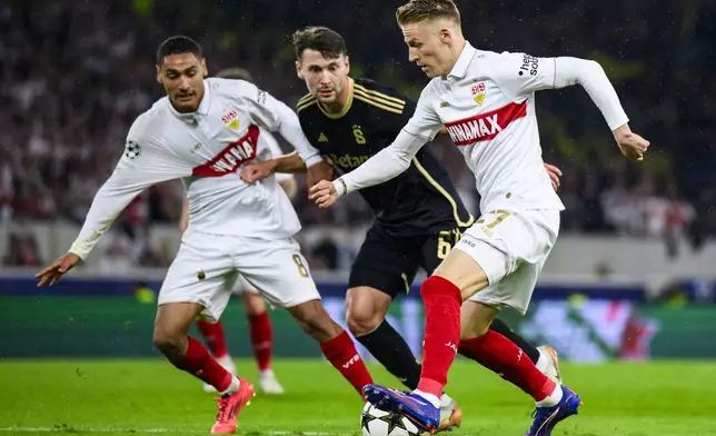 Stuttgart's Chris Führich, right, and Enzo Millot, left, challenge for the ball with Prague's Kaan Kairinen, center, during the Champions League opening phase soccer match between VfB Stuttgart and AC Sparta Praha in Stuttgart, Germany, Tuesday, Oct. 1, 2024. (Tom Weller/dpa via AP)